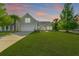 Charming home with a well-manicured lawn, beautiful landscaping, and a two-car garage at 7601 Stargazer Dr, Hanahan, SC 29410