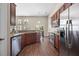 Updated kitchen featuring stainless steel appliances, granite counters, and dark wood cabinets at 7601 Stargazer Dr, Hanahan, SC 29410