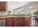 Kitchen with stainless dishwasher, cabinets, granite counters, and opening into the living room at 7601 Stargazer Dr, Hanahan, SC 29410
