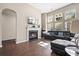 Bright living room featuring fireplace, lots of windows, and dark leather furniture at 7601 Stargazer Dr, Hanahan, SC 29410