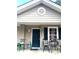 The home has a cozy front porch featuring a seating area with a table and chairs at 7943 Vermont Rd, North Charleston, SC 29418