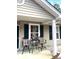 Inviting front porch featuring two swivel chairs and a small table with a plant at 7943 Vermont Rd, North Charleston, SC 29418