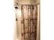 Shower with a decorative shower curtain and a built-in shower caddy at 7943 Vermont Rd, North Charleston, SC 29418