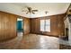 Spacious living room with vintage paneling, ceiling fan, fireplace, and natural light, providing a warm and inviting space at 813 W 1St North St, Summerville, SC 29483