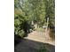 Spacious backyard deck with a grill and a peaceful view overlooking lush landscaping and a tranquil pond at 815 W Carolina Rd, McClellanville, SC 29458