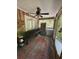 Enclosed porch with paneled walls, rustic bench, large window, and durable rug with outdoor view at 815 W Carolina Rd, McClellanville, SC 29458