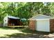 Spacious backyard featuring a detached garage, custom wood shed and a picnic area with mature trees at 816 Savage Rd, Charleston, SC 29414