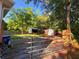 Gated yard featuring a shed and detached garage surrounded by mature trees and a wooden fence at 816 Savage Rd, Charleston, SC 29414