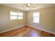 Bright bedroom features hardwood flooring, two windows and neutral walls and decor at 816 Savage Rd, Charleston, SC 29414