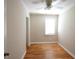 This simple bedroom features a ceiling fan, painted paneled walls, and hardwood flooring at 816 Savage Rd, Charleston, SC 29414