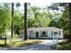 Charming single-story home featuring light blue siding, a dark roof, an American flag, and a well-maintained front yard at 816 Savage Rd, Charleston, SC 29414