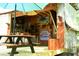 Exterior view of an outdoor structure with picnic table, covered area with bar, and eclectic decorations at 816 Savage Rd, Charleston, SC 29414