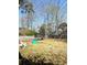 Spacious backyard featuring a trampoline, swing set, and wooden fence at 8330 Longridge Rd, North Charleston, SC 29418