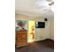 Bedroom featuring wall-mounted TV, ceiling fan, view into the bathroom, and closet storage at 8330 Longridge Rd, North Charleston, SC 29418
