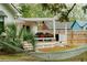 Inviting backyard with a covered patio with dining set and grill, surrounded by lush greenery, ideal for outdoor living at 847 Condon Dr, James Island, SC 29412