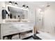 Bright bathroom features a double vanity, marble countertop, and glass shower with geometric tiled floors at 847 Condon Dr, James Island, SC 29412