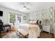 Stylishly designed bedroom with natural lighting, a ceiling fan, and a decorative accent wall at 847 Condon Dr, James Island, SC 29412