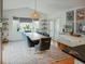 Bright dining room features a large window, modern lighting, and seating for eight at 847 Condon Dr, James Island, SC 29412