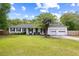 Charming home exterior with a well-kept lawn, white brick, and attached garage at 847 Condon Dr, James Island, SC 29412