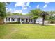 Well-maintained home with lush green lawn, mature trees, and a welcoming front entrance at 847 Condon Dr, James Island, SC 29412
