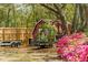 Red shed with rustic charm, trailer, and vibrant pink azaleas in a lush, green backyard at 847 Condon Dr, James Island, SC 29412