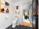 Modern bathroom features a toilet with black geometric tiled floors and artwork hanging on the wall at 847 Condon Dr, James Island, SC 29412