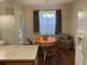 Bright dining nook with wooden table, chairs, and stylish curtains at 8634 Grassy Oak Trl, North Charleston, SC 29420