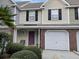 Charming townhome featuring a purple front door and a one car garage at 8634 Grassy Oak Trl, North Charleston, SC 29420