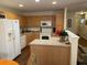 Spacious kitchen with wooden cabinets, white appliances, and breakfast bar at 8634 Grassy Oak Trl, North Charleston, SC 29420