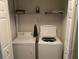 Convenient laundry area with washer, dryer, and open shelving at 8634 Grassy Oak Trl, North Charleston, SC 29420