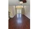 Bright open-concept room with hardwood floors, featuring stairs, white front door, and a ceiling fan at 9032 Maple Grove Dr, Summerville, SC 29485