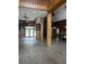 Open living area with rustic wooden beams and floors, with stairs leading to a loft area at 9032 Maple Grove Dr, Summerville, SC 29485