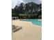 Community pool with lounge chairs, palm trees, and mature trees surrounding the area at 9032 Maple Grove Dr, Summerville, SC 29485