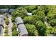 Aerial view showing townhomes near a pool with beautiful surrounding trees and landscaping at 9042 Parlor Dr, Ladson, SC 29456