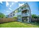 View of backyard with fence, a patio with chairs, and the back of a multi-story home with balconies at 9042 Parlor Dr, Ladson, SC 29456