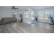 Spacious living room with ample natural light, neutral paint, and sliding door to backyard at 9042 Parlor Dr, Ladson, SC 29456