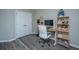 Office featuring a computer desk with shelves, white rolling chair and a pair of double closet doors at 9042 Parlor Dr, Ladson, SC 29456