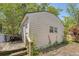 Detached garage with a small porch, set amidst lush greenery and mature trees at 1012 Cliffwood Dr, Mount Pleasant, SC 29464