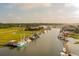 Aerial view of a charming waterfront with boats docked and lush greenery along the shores at 1012 Cliffwood Dr, Mount Pleasant, SC 29464