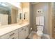 This well-lit bathroom has a double sink vanity, and a tiled shower in the attached water closet at 1025 Riverland Woods Pl # 906, Charleston, SC 29412