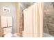 Bright bathroom features decorative tile surround and a white shower curtain at 1025 Riverland Woods Pl # 906, Charleston, SC 29412