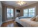 This cozy bedroom features natural light and hardwood flooring throughout at 1025 Riverland Woods Pl # 906, Charleston, SC 29412