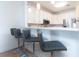 Bar seating provides additional dining space adjacent to the kitchen with modern stainless appliances at 1025 Riverland Woods Pl # 906, Charleston, SC 29412