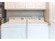 Convenient laundry area with washer, dryer, and overhead storage at 1025 Riverland Woods Pl # 906, Charleston, SC 29412