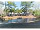 Scenic waterfront view with lush landscaping, palm trees, and charming community buildings at 1025 Riverland Woods Pl # 906, Charleston, SC 29412