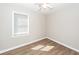 This bedroom features modern vinyl flooring, a ceiling fan, a window with blinds, and neutral paint at 119 Carolina Wren Ave, Ladson, SC 29456