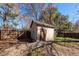 Backyard shed with a wooden door, offering additional storage space in the fenced yard at 119 Carolina Wren Ave, Ladson, SC 29456