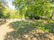 A serene fenced backyard with plenty of mature trees offering ample shade and seclusion at 1128 Melvin Bennett Rd, Mount Pleasant, SC 29464