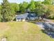 Charming single-story home features mature trees, a wide lawn, and a paved driveway at 1128 Melvin Bennett Rd, Mount Pleasant, SC 29464