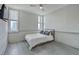 This bedroom features hardwood floors, a ceiling fan, large windows, and a queen bed with neutral bedding at 14 Lockwood Dr # 11H, Charleston, SC 29401